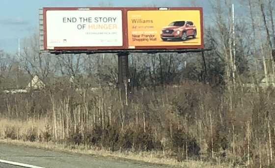 2 signs on 1 billboard face