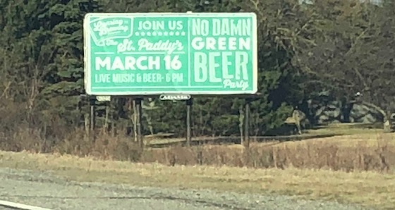 white letters on green billboard